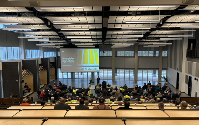 Lecturer speaking to an auditorium full of county highway employees