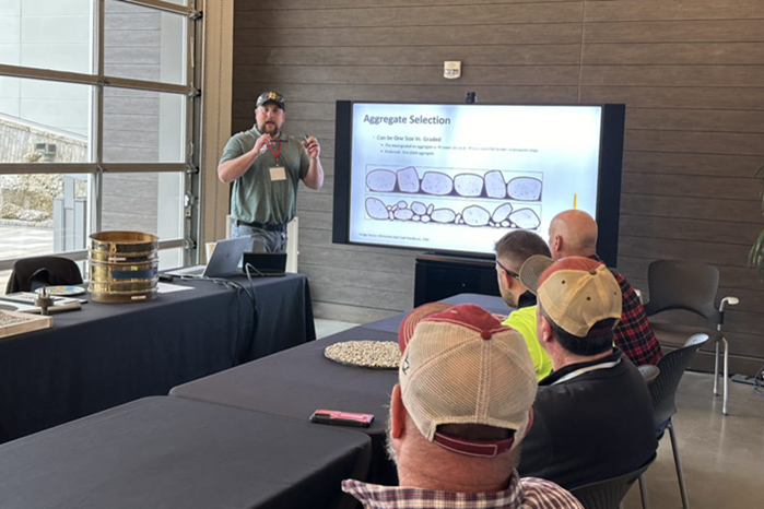 Instructor leading a class on material selection