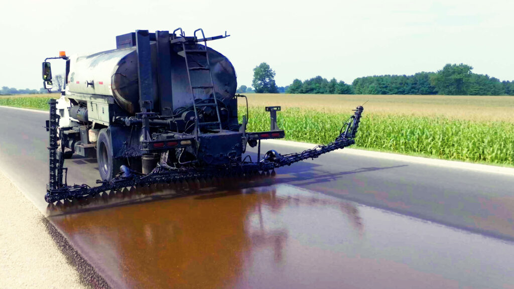 Job site photo: Distributor truck spraying rapid penetrating emulsion being applied in Dodge County Wisconsin